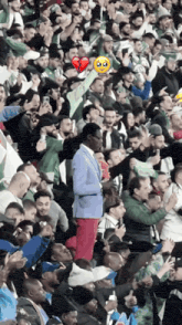 a man in a blue suit is standing in a crowd of people