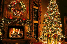 two christmas trees are lit up in a living room with a fireplace