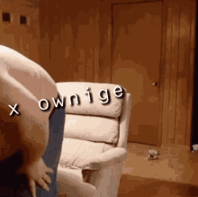 a man standing next to a recliner with the words " x ownige " on it