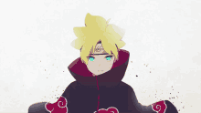 a boy with yellow hair and blue eyes is wearing a black cape with red clouds