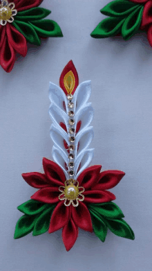 a red white and green flower with a candle on it