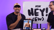 a man holds a picture of anthony owens in front of a sign that says hey ew