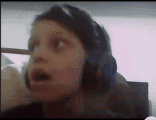 a person wearing headphones looks surprised in this blurry photo