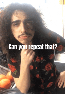 a man with long curly hair and a mustache has the words can you repeat that above him