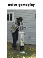 a man standing next to a machine that says noise gameplay on the bottom