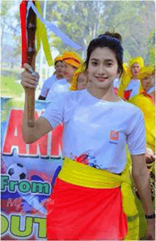 a woman holds a torch in front of a sign that says " from "