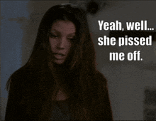 a woman with long hair is standing in front of a sign that says " yeah well she pissed me off "