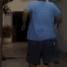 a man in a blue shirt and shorts is running down a street .