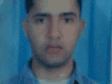 a blurry photo of a man with a blue background