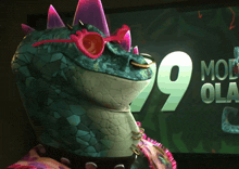 a cartoon character wearing pink sunglasses stands in front of a screen that says 99