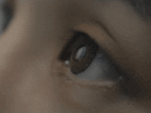 a close up of a woman 's eye shows the pupil