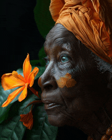 a close up of a woman 's face with a flower in front of it