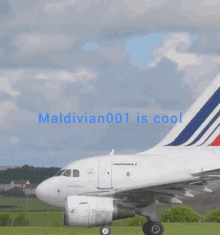 a white air france plane is sitting on the runway