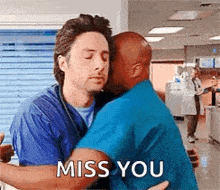 two men are hugging each other in a hospital room and one of them is kissing the other .