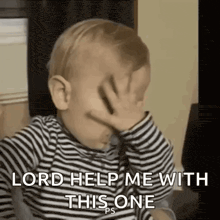 a baby is covering his face with his hand and asking for help .
