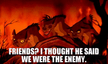 a group of hyenas are standing next to each other in front of a burning forest .