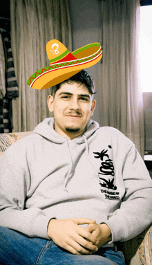 a man with a sombrero on his head and a hoodie that says ' the world '