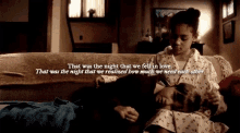 a couple of girls are laying on a couch with a quote .