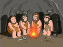 a group of cavemen sitting around a campfire in a cave