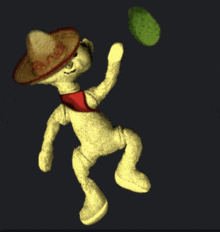 a teddy bear wearing a sombrero and a red tie throws a ball