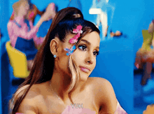 a woman with flowers in her hair says yuh on the bottom