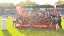 a group of soccer players are posing for a photo in front of a banner that says ' regionalsieger 2022 '