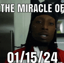 a man wearing a black hat and a red and white shirt says the miracle of 01/15/24