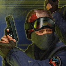 a man wearing a mask and goggles holds a gun in his hand