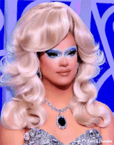 a close up of a woman wearing a wig and a necklace that says tumblr on the bottom
