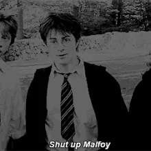 a black and white photo of harry potter with the words shut up malfoy below him