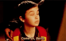 a young boy is talking to someone and says come on barry .