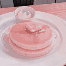 a pink pancake with syrup and butter on top of it