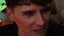 a close up of a man 's face with a serious expression .