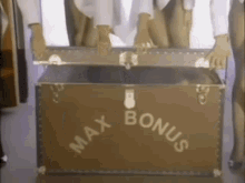 a group of people are holding a trunk that says max bonus