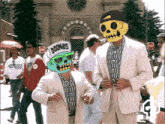 a man wearing a goonies hat is standing next to another man in a suit