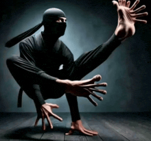 a man in a ninja costume is squatting down with his legs crossed