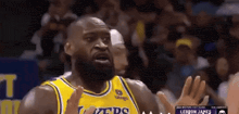 a basketball player wearing a yellow jersey that says lakers