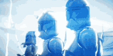 a group of clone troopers are standing next to each other in a blue light