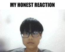 a boy wearing glasses and ear buds with the words my honest reaction below him