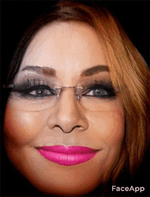 a close up of a woman 's face with glasses and pink lipstick with faceapp written below it