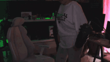 a person wearing a white shirt that says total freaky