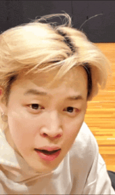 a close up of a person 's face with a surprised look on their face