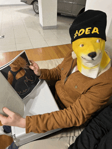 a person wearing a mask and a hat that says $ dea is reading a magazine