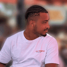 a man wearing a white t-shirt that says love the people