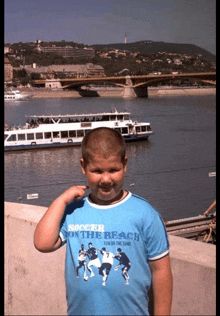 a boy wearing a soccer on the beach shirt