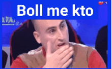a man covering his mouth with his hand and the words boll me kto written above him