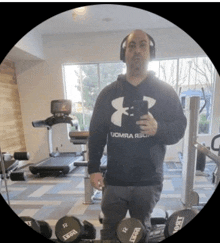 a man wearing a black under armour hoodie takes a selfie