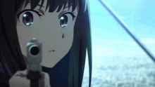 a close up of a girl pointing a gun at something