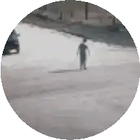 a blurry picture of a person walking down a street in a circle
