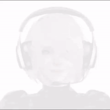 a girl wearing headphones and a microphone is smiling .